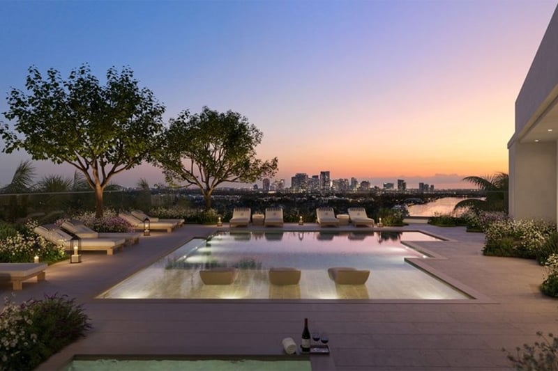 Rooftop pool terrace at The Ritz-Carlton Residences, Fort Lauderdale, showing amenities for luxury and ultra luxury condos, including a sunset lounge deck, in-water seating, and landscaped skyline views.