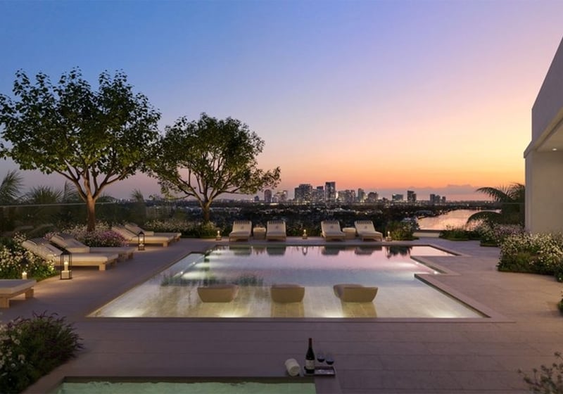 Rooftop pool terrace at The Ritz-Carlton Residences, Fort Lauderdale, showing amenities for luxury and ultra luxury condos, including a sunset lounge deck, in-water seating, and landscaped skyline views.
