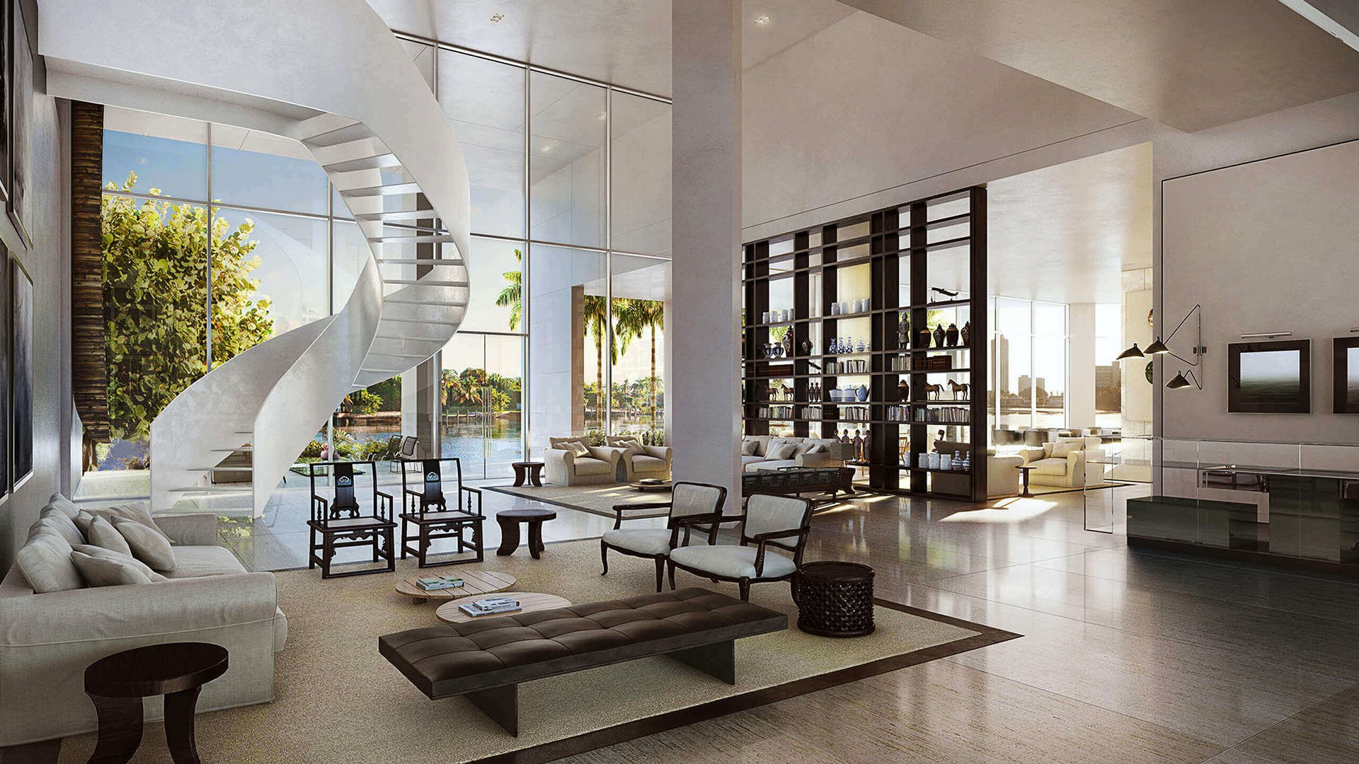Double-height great room with a sculptural spiral staircase and waterfront glazing at The Ritz-Carlton Residences Miami Beach in Miami Beach, inside the luxury and ultra luxury condos.