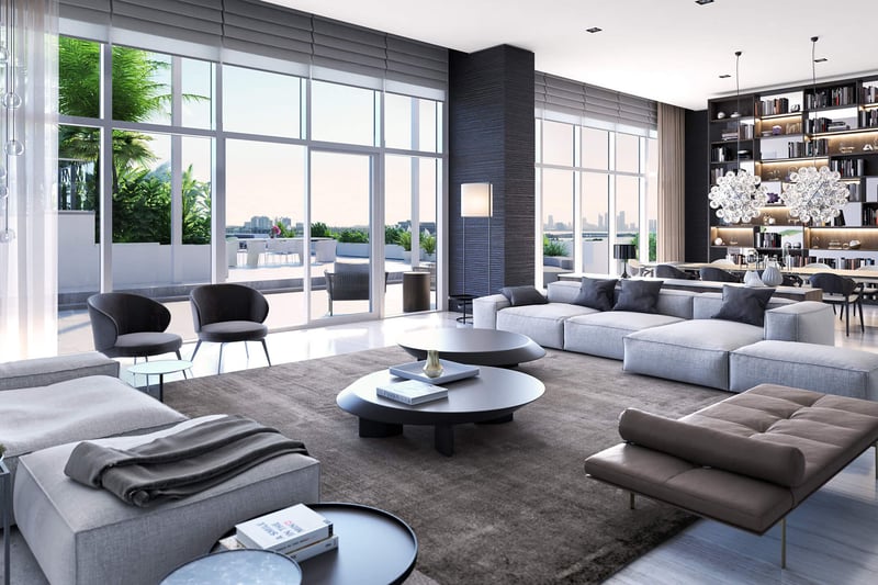 Grand living room with a library dining area, double-height glass and terrace access at The Ritz-Carlton Residences Miami Beach in Miami Beach, inside the luxury and ultra luxury condos.