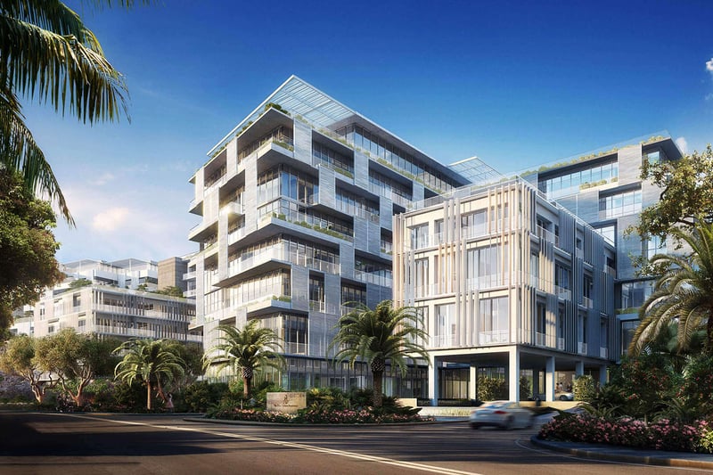 Palm-lined corner exterior entrance at The Ritz-Carlton Residences Miami Beach in Miami Beach, showing luxury and ultra luxury condos with layered glass balconies and lush landscaping.