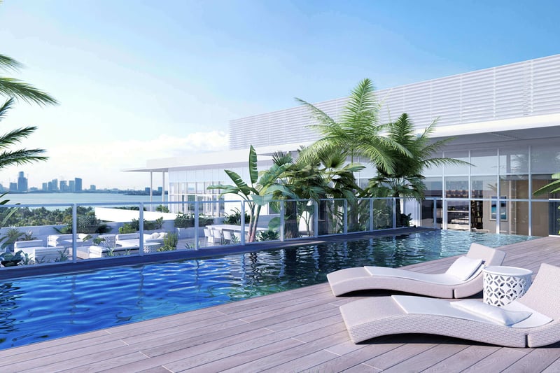 Rooftop pool terrace with palm plantings, chaise loungers and skyline views at The Ritz-Carlton Residences Miami Beach in Miami Beach, an amenity for the luxury and ultra luxury condos.
