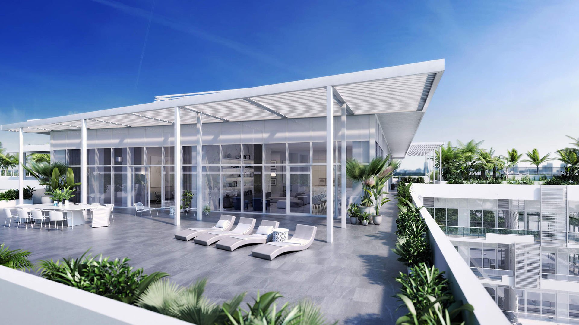 Rooftop sundeck pavilion with loungers, outdoor dining and lush planters at The Ritz-Carlton Residences Miami Beach in Miami Beach, an amenity for the luxury and ultra luxury condos.