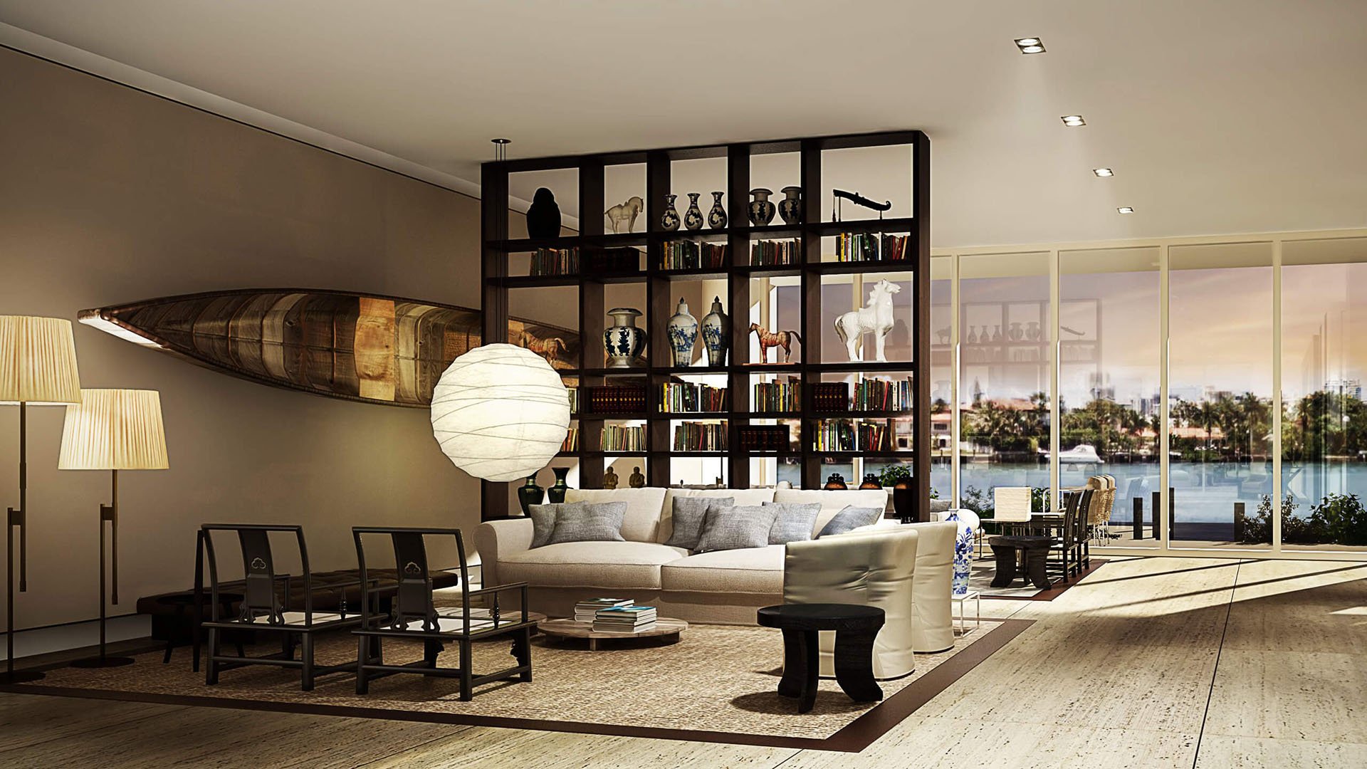 Waterfront living room with a library divider and canoe wall art at The Ritz-Carlton Residences Miami Beach in Miami Beach, inside the luxury and ultra luxury condos.