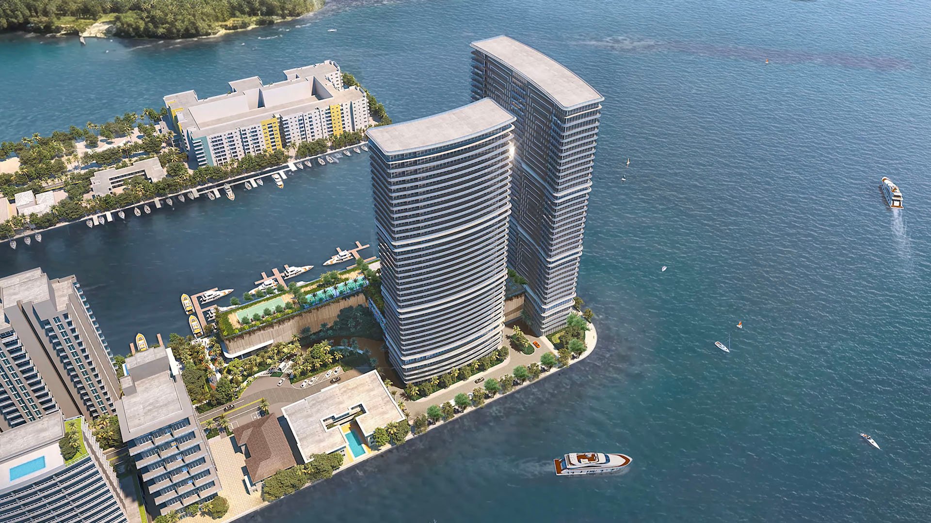Aerial view of The Ritz-Carlton Residences, North Bay Village, showing two waterfront towers, marina slips and a long pool deck for luxury and ultra luxury condos in this preconstruction bayfront development.