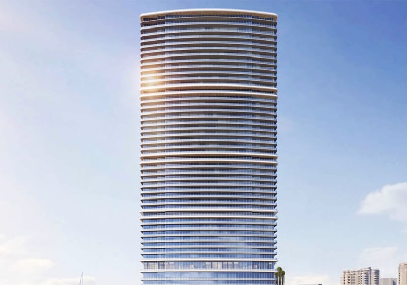 Front elevation of a tall curved glass tower at The Ritz-Carlton Residences, North Bay Village, highlighting the sleek facade of luxury and ultra luxury condos in this preconstruction waterfront development.