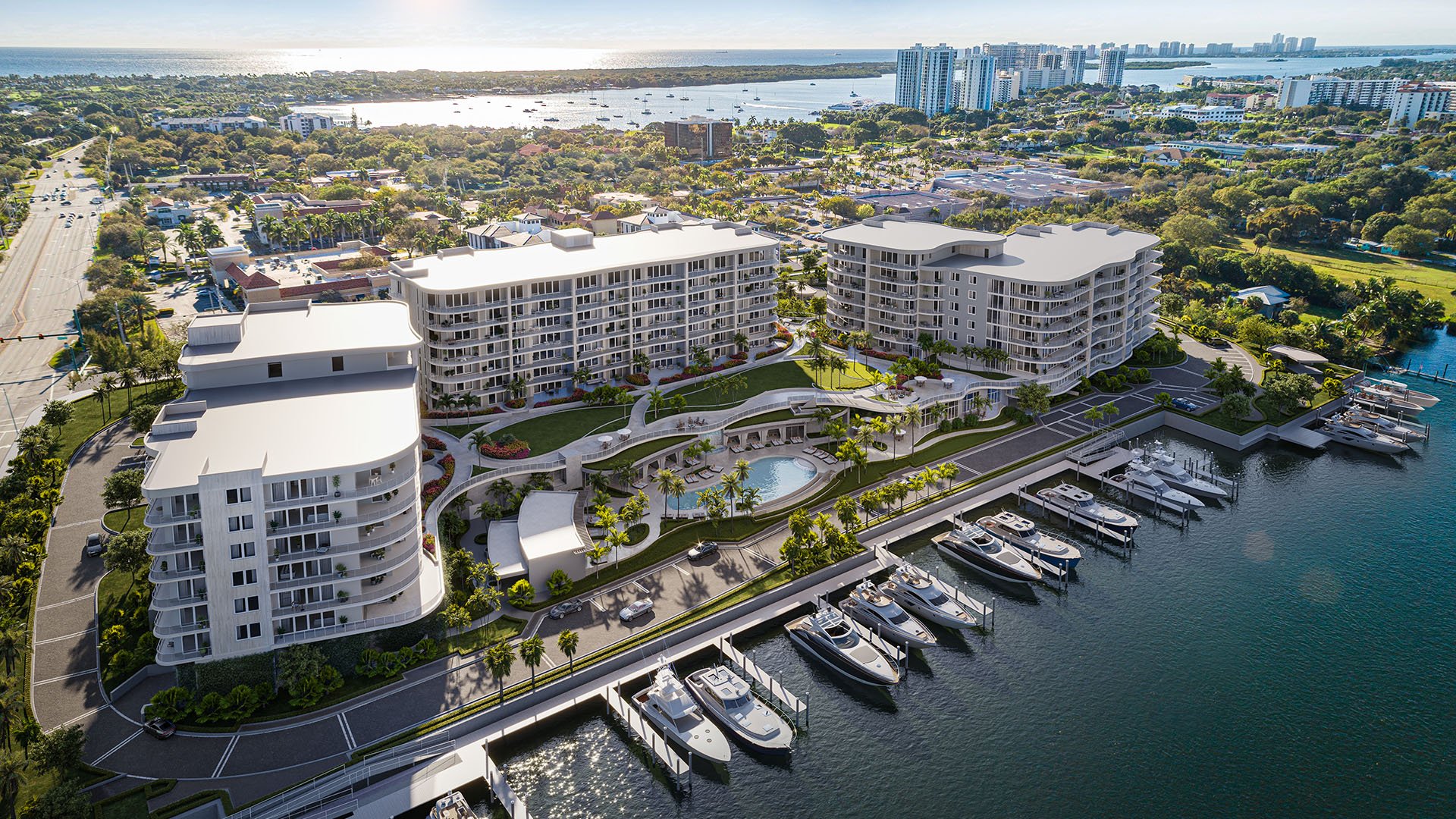 Aerial view of The Ritz-Carlton Residences Palm Beach Gardens waterfront marina and resort pool, Palm Beach Gardens, Florida, showcasing luxury and ultra luxury preconstruction condos with private yacht slips on the Intracoastal Waterway.