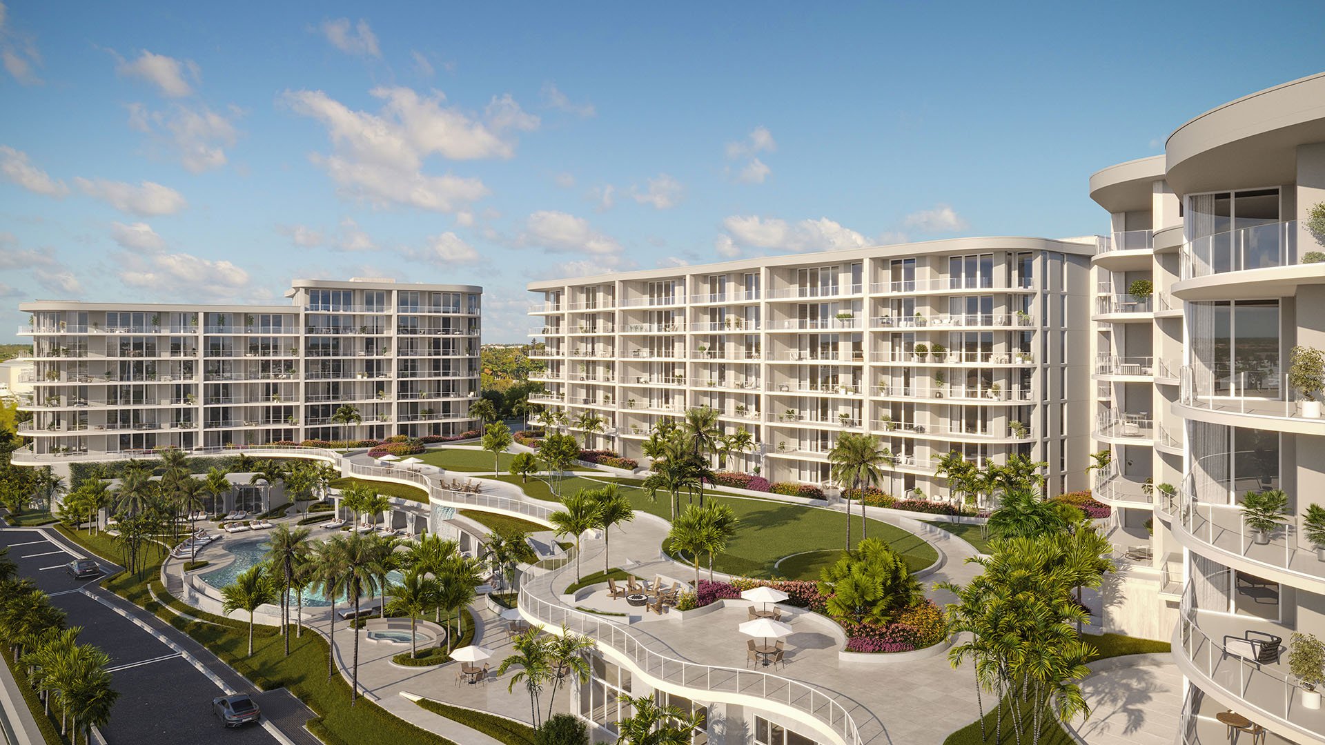 Landscaped courtyard amenity deck and resort-style pool between towers at The Ritz-Carlton Residences Palm Beach Gardens, Palm Beach Gardens, Florida, featuring luxury and ultra luxury preconstruction condos with palm-lined terraces.