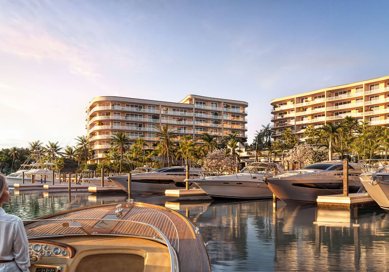 Sunset marina view with yachts at private docks in front of The Ritz-Carlton Residences Palm Beach Gardens, Palm Beach Gardens, Florida, showcasing luxury and ultra luxury preconstruction condos with waterfront lifestyle on the Intracoastal Waterway.