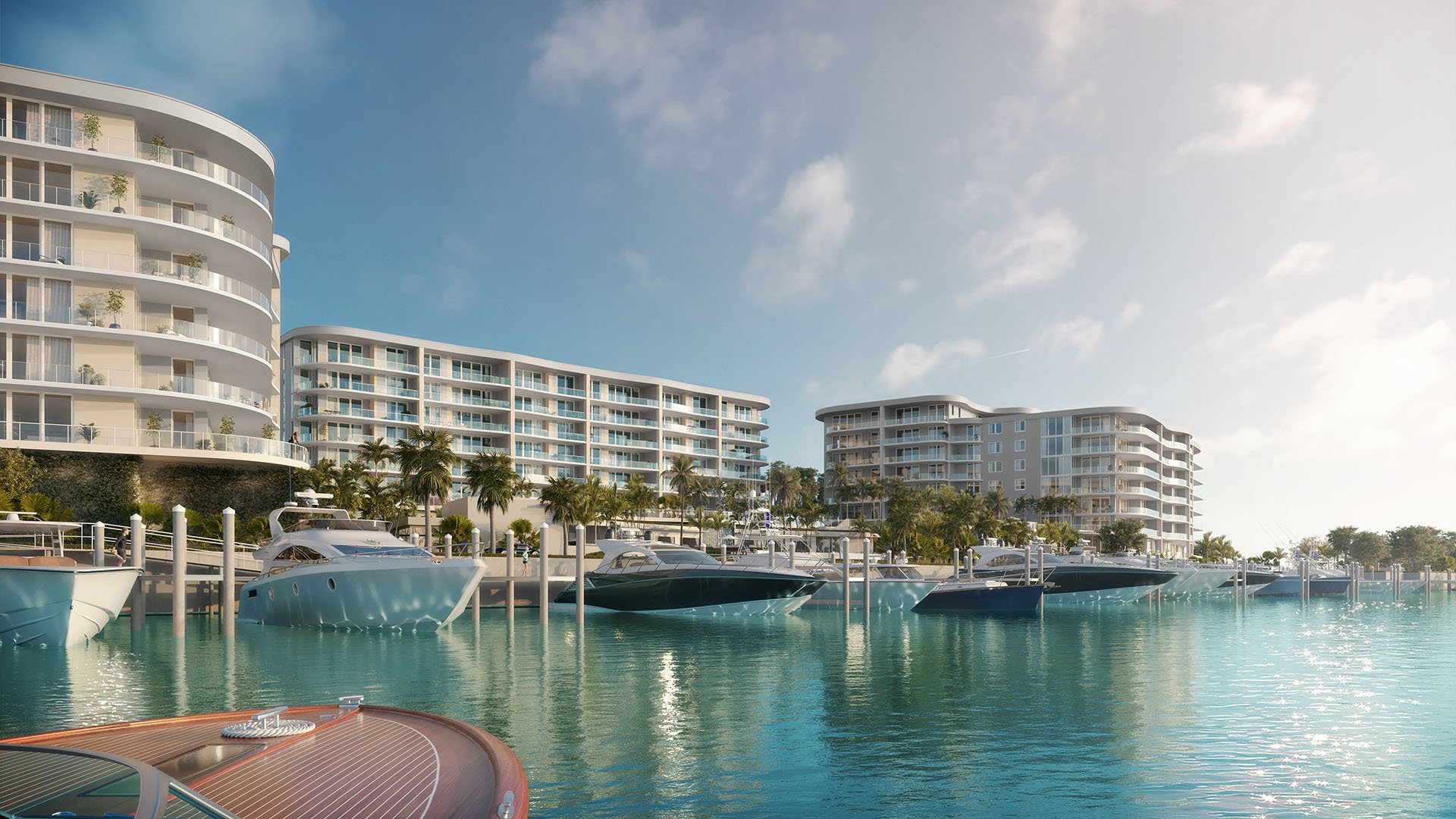 Daytime marina scene with private yacht slips and waterfront towers at The Ritz-Carlton Residences Palm Beach Gardens, Palm Beach Gardens, Florida, highlighting luxury and ultra luxury preconstruction condos on the Intracoastal Waterway.