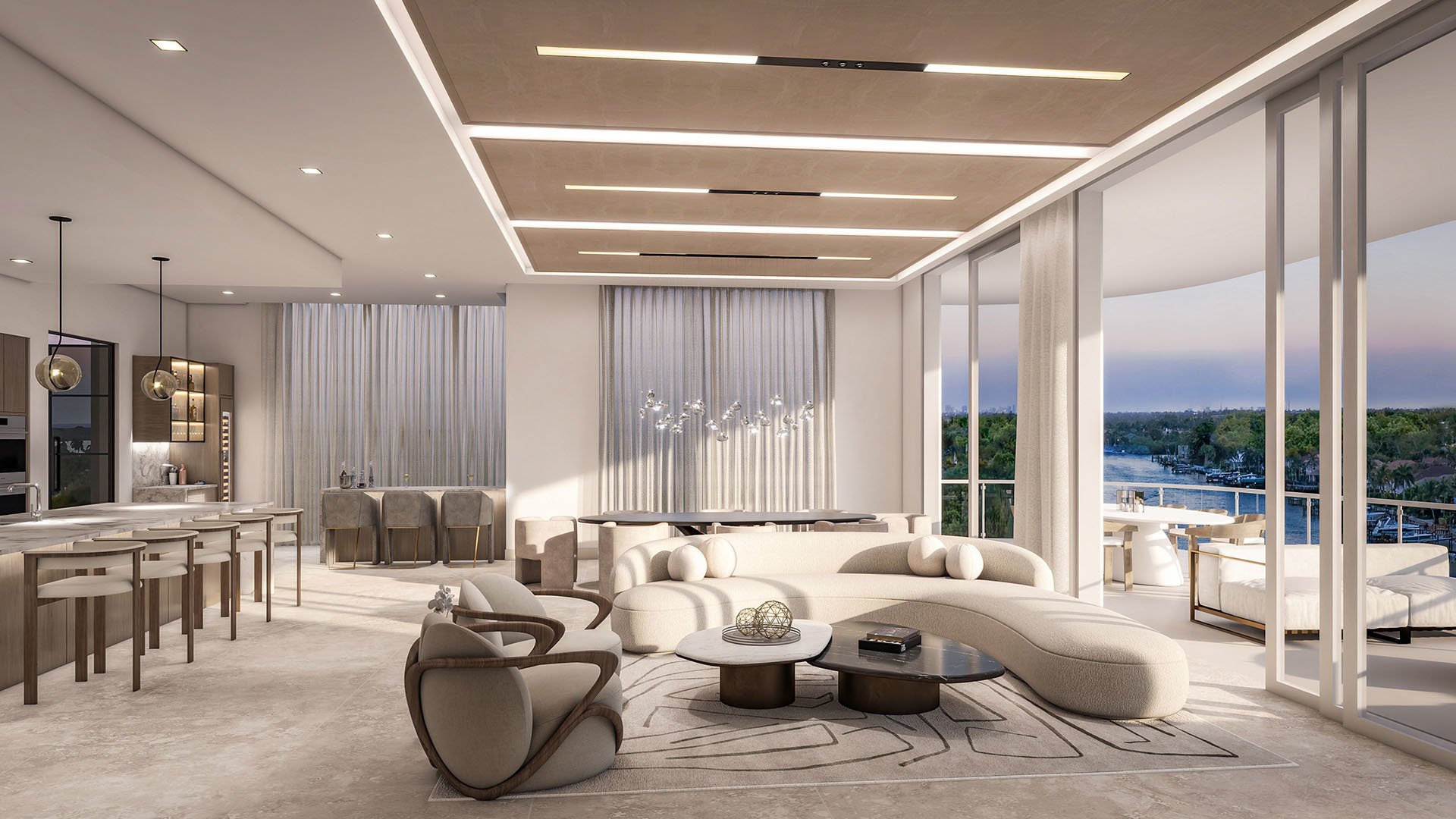 Residence A great room with curved sofa, designer seating, kitchen island and sliding glass doors to a water-view balcony at The Ritz-Carlton Residences Palm Beach Gardens, Palm Beach Gardens, Florida, showcasing luxury and ultra luxury preconstruction condos.