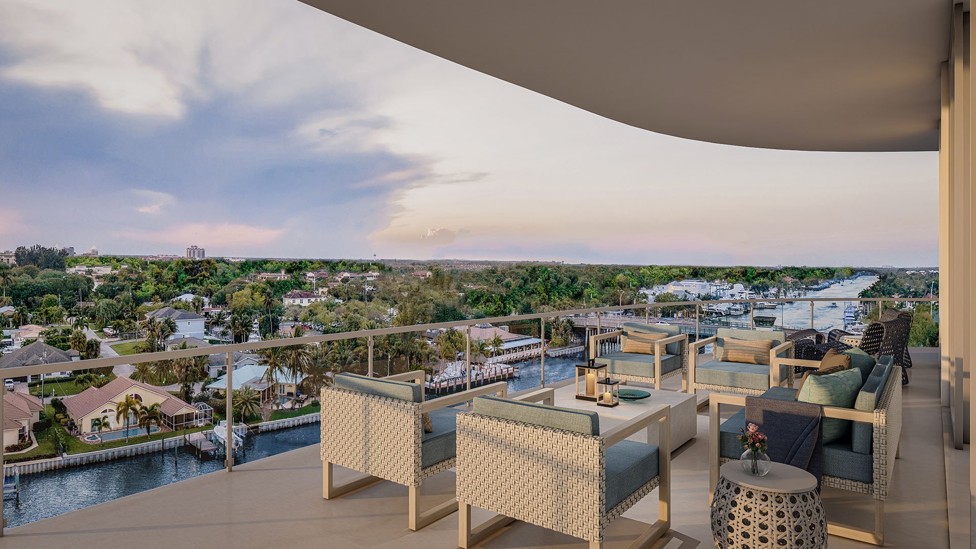 Residence C north balcony with curved outdoor lounge seating and sweeping Intracoastal Waterway sunset view at The Ritz-Carlton Residences, Palm Beach Gardens, Florida, showcasing luxury and ultra luxury preconstruction condos.