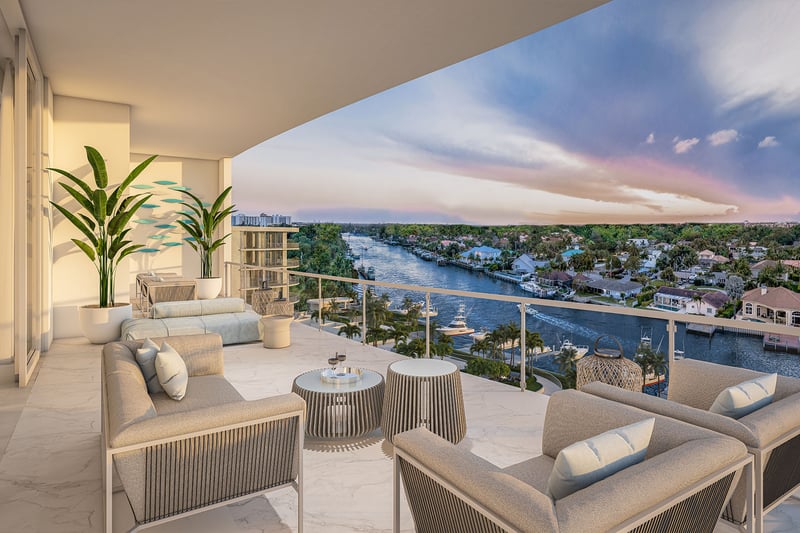 The Ritz-Carlton Residences, Palm Beach Gardens FL east building balcony with modern outdoor lounge on marble flooring, panoramic Intracoastal waterway sunset views, highlighting luxury and ultra luxury preconstruction condos waterfront living.