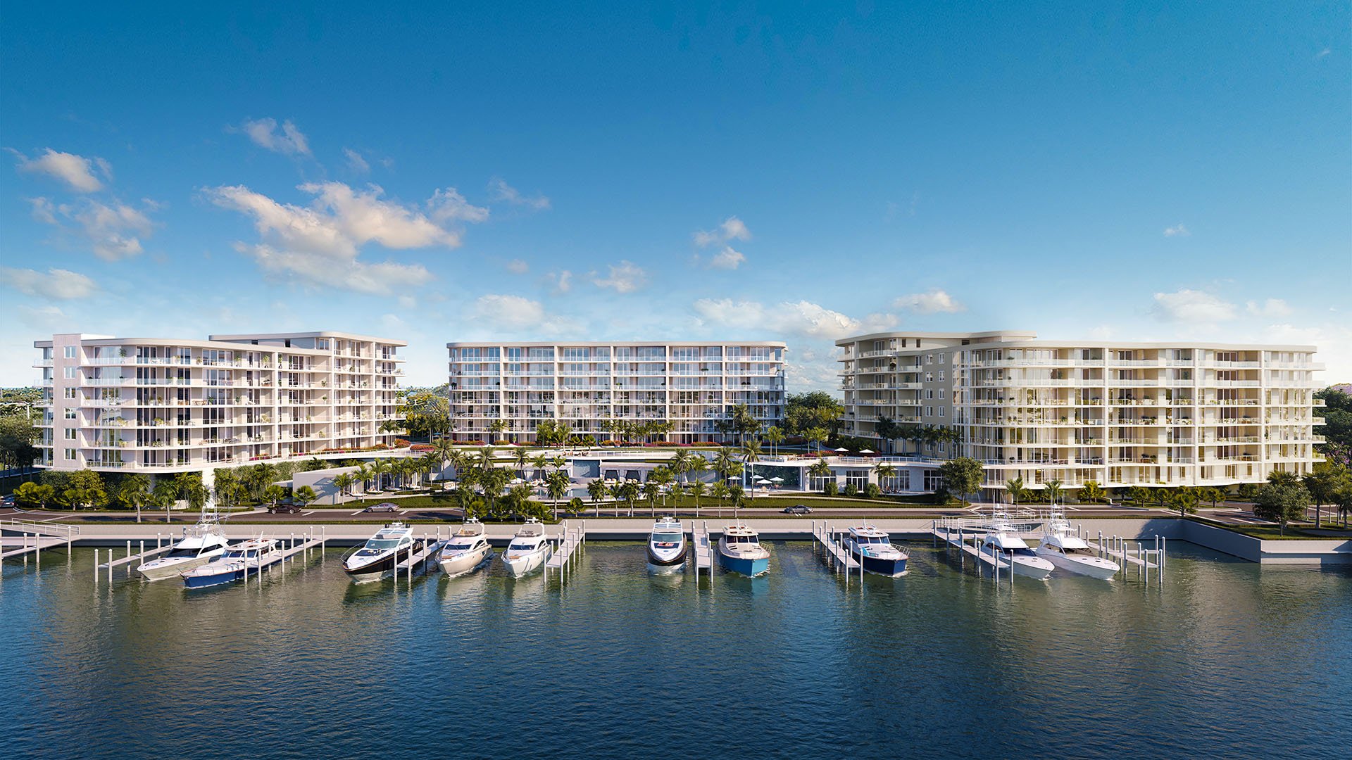 The Ritz-Carlton Residences, Palm Beach Gardens FL marina-front elevation with waterfront buildings and private yacht slips, illustrating luxury and ultra luxury preconstruction condos community on the Intracoastal.