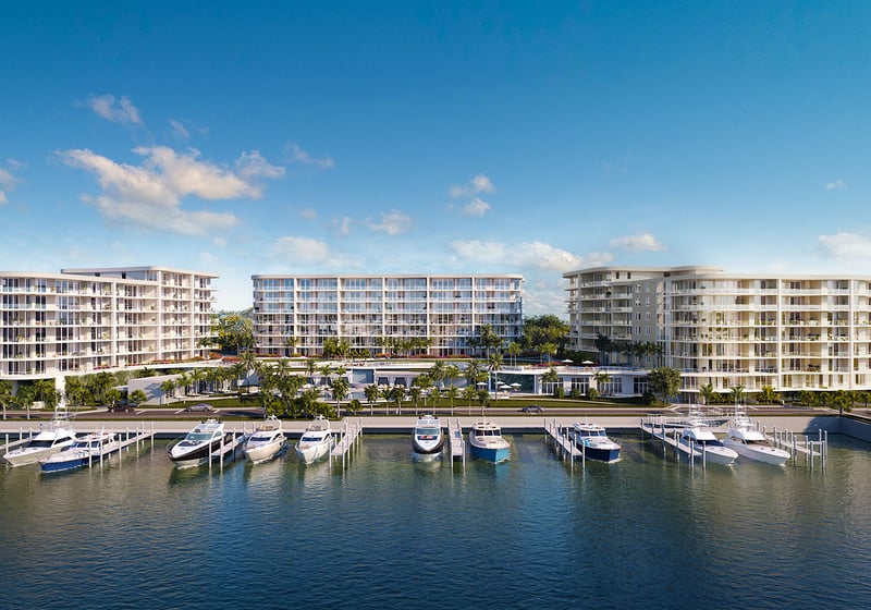 The Ritz-Carlton Residences, Palm Beach Gardens FL marina-front elevation with waterfront buildings and private yacht slips, illustrating luxury and ultra luxury preconstruction condos community on the Intracoastal.