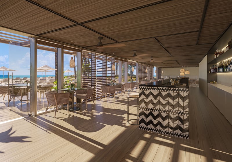 Oceanfront beach club restaurant and bar at The Ritz-Carlton Residences Pompano Beach, Florida Beach Tower, with indoor-outdoor dining overlooking the beach, representing luxury and ultra luxury preconstruction condos lifestyle.