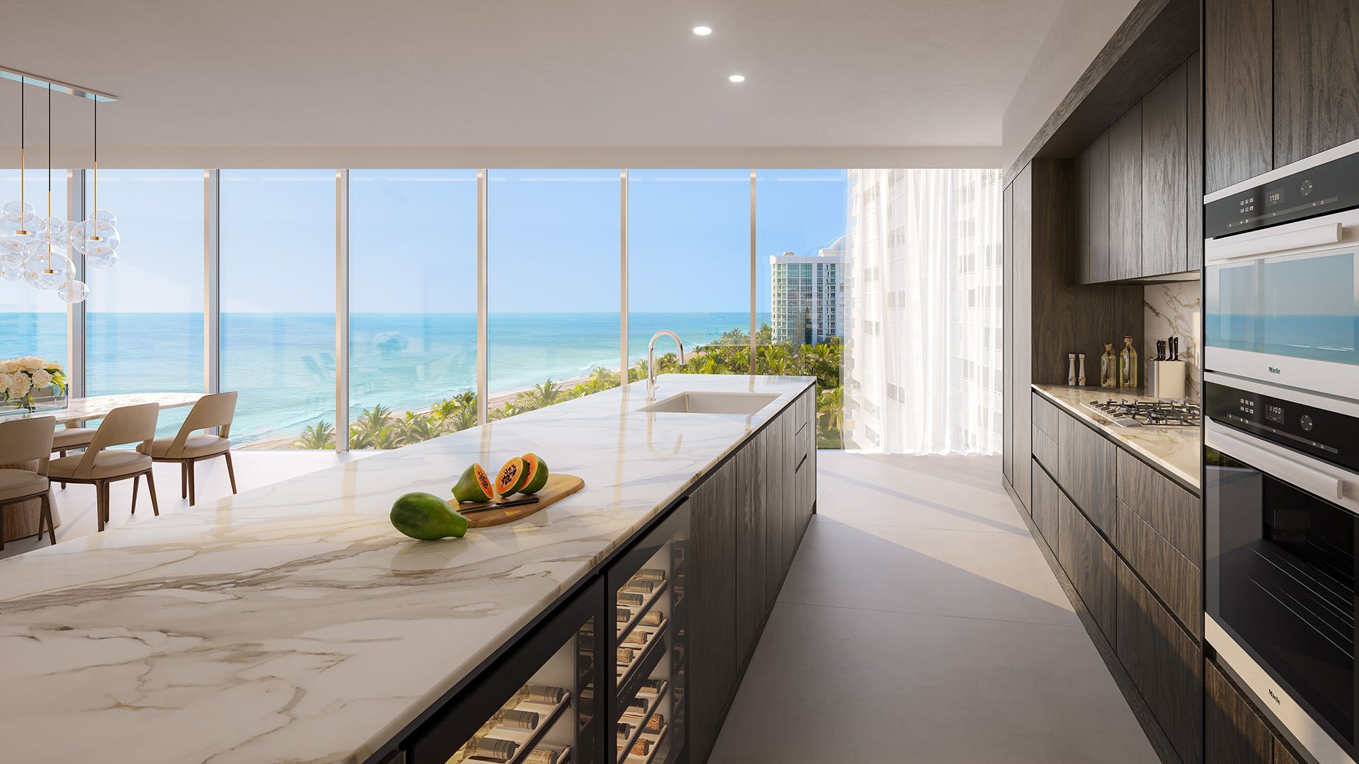 Residence 01 modern kitchen at The Ritz-Carlton Residences Pompano Beach, Florida Beach Tower with marble waterfall island, premium appliances and ocean views, showcasing luxury and ultra luxury preconstruction condos interiors.