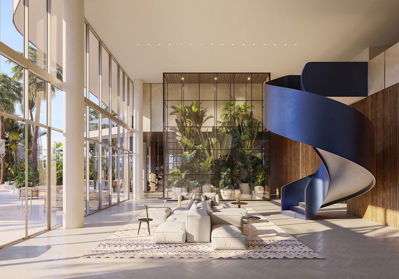 Marina Tower luxury lobby at The Ritz-Carlton Residences Pompano Beach, Florida featuring dramatic blue spiral staircase, tropical indoor garden and glass walls, reflecting luxury and ultra luxury preconstruction condos arrival experience.