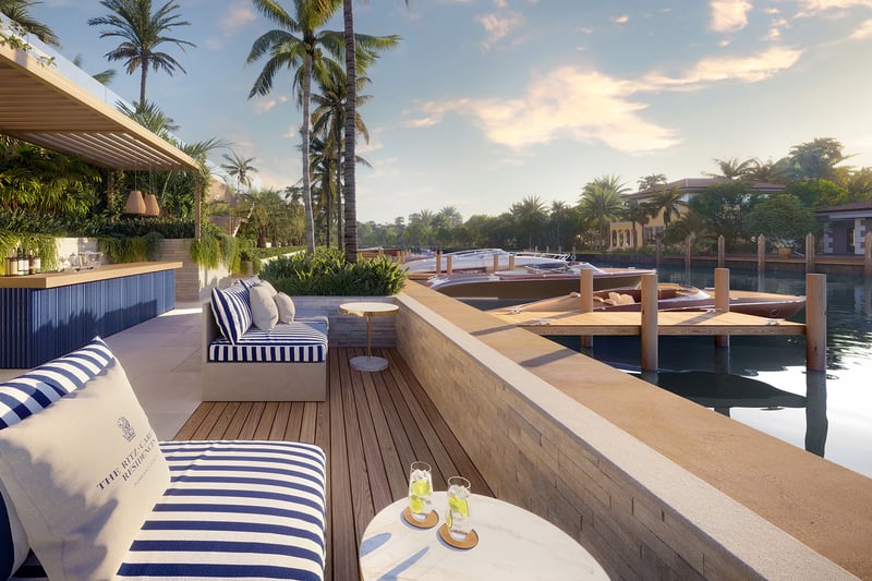 Sundowners outdoor bar lounge at The Ritz-Carlton Residences Pompano Beach Marina Tower with striped seating, sunset cocktails, private dock and yachts on the marina canal, showcasing luxury and ultra luxury preconstruction waterfront condos in Pompano Beach, Florida.