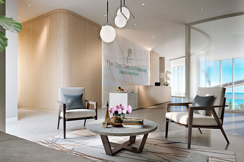 Arrival lobby with reception desk, seating area, and ocean light at The Ritz-Carlton Residences, Sunny Isles Beach, luxury and ultra luxury condos in Sunny Isles Beach.