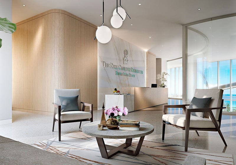 Arrival lobby with reception desk, seating area, and ocean light at The Ritz-Carlton Residences, Sunny Isles Beach, luxury and ultra luxury condos in Sunny Isles Beach.