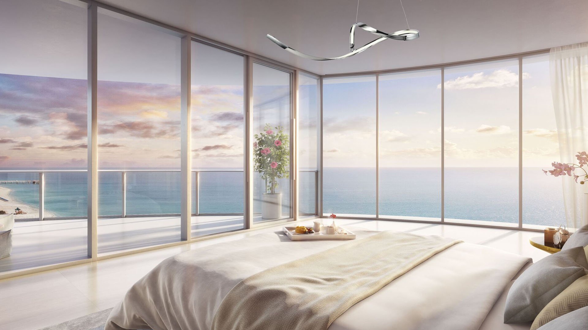 Corner bedroom with wraparound glass and open ocean views at The Ritz-Carlton Residences, Sunny Isles Beach, luxury and ultra luxury condos in Sunny Isles Beach.