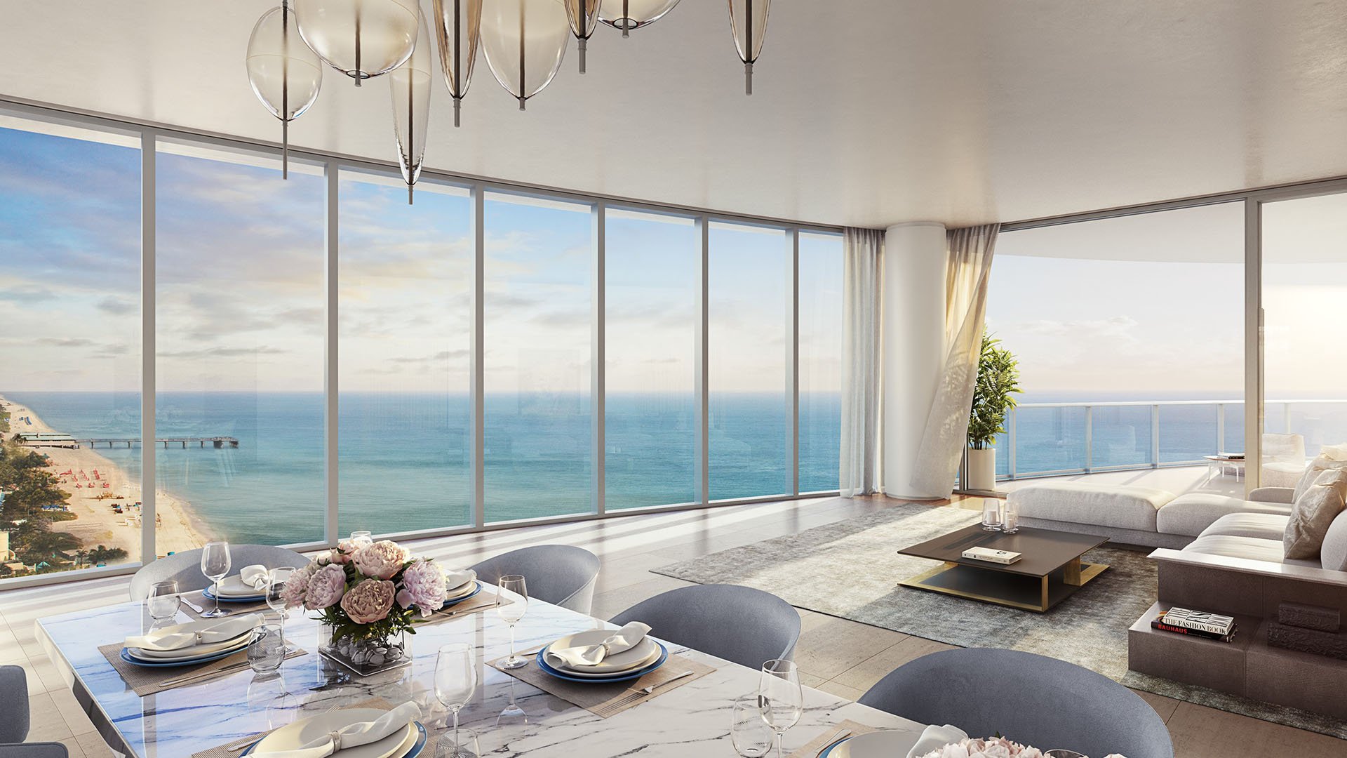 Corner living and dining room with a wide beachfront panorama at The Ritz-Carlton Residences, Sunny Isles Beach, luxury and ultra luxury condos in Sunny Isles Beach.