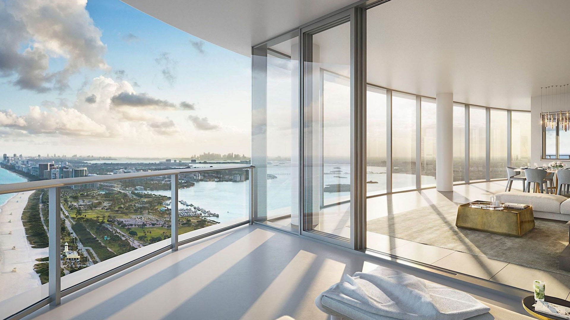 Corner terrace with sweeping aerial waterfront views and open living space at The Ritz-Carlton Residences, Sunny Isles Beach, luxury and ultra luxury condos in Sunny Isles Beach.