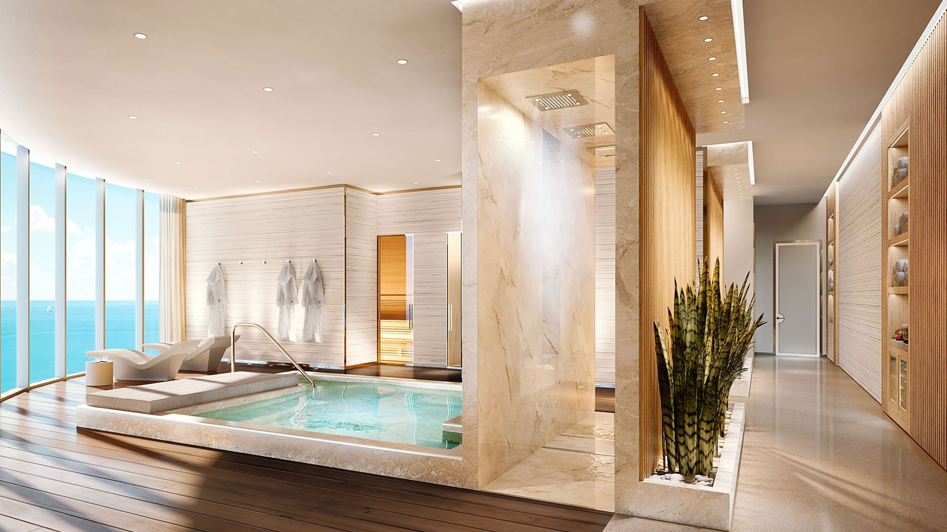 Indoor spa suite with a hydrotherapy pool, loungers, and ocean views at The Ritz-Carlton Residences, Sunny Isles Beach, luxury and ultra luxury condos in Sunny Isles Beach.