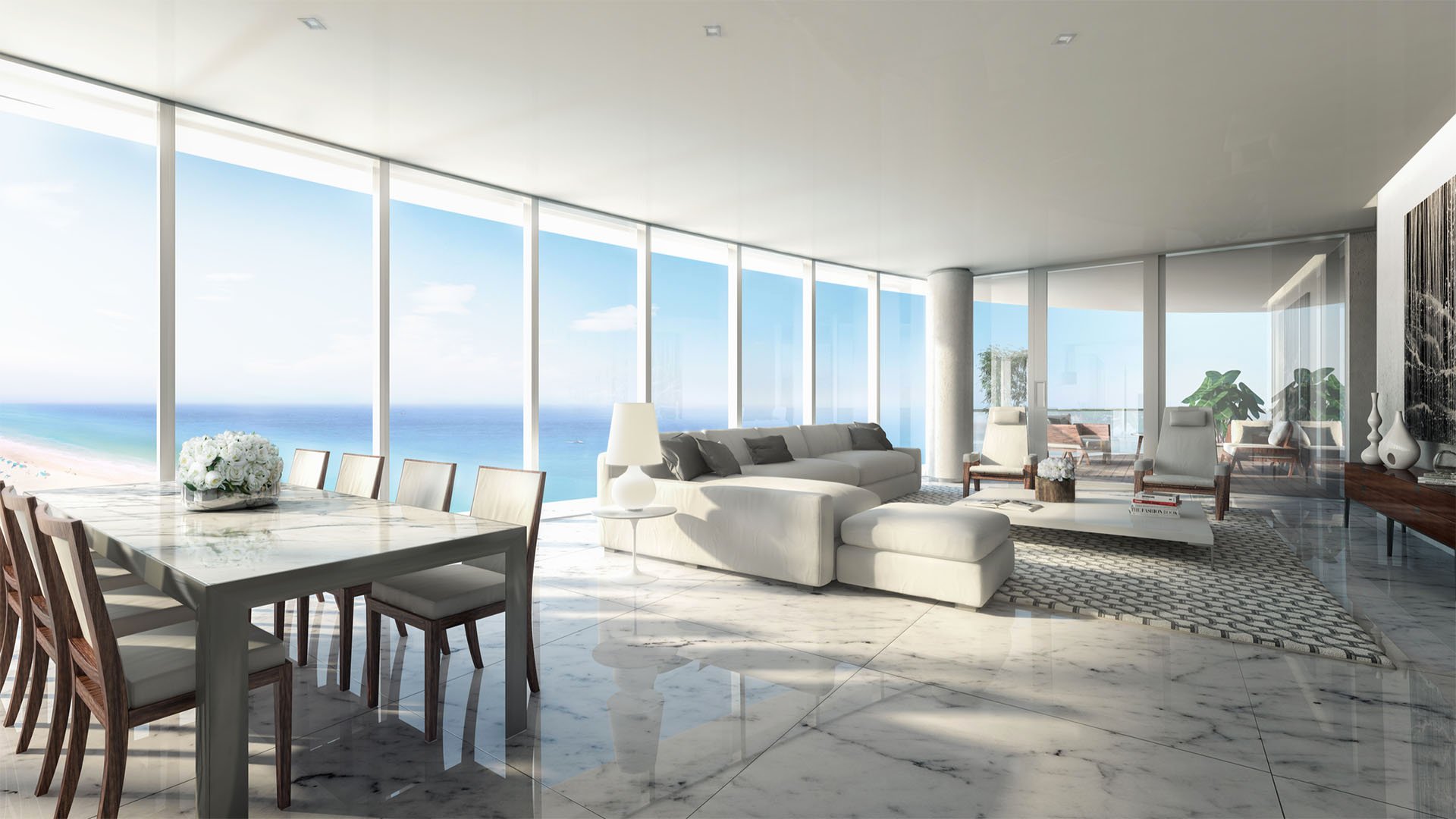 Open living and dining area with marble floors and floor-to-ceiling oceanfront glass at The Ritz-Carlton Residences, Sunny Isles Beach, luxury and ultra luxury condos in Sunny Isles Beach.