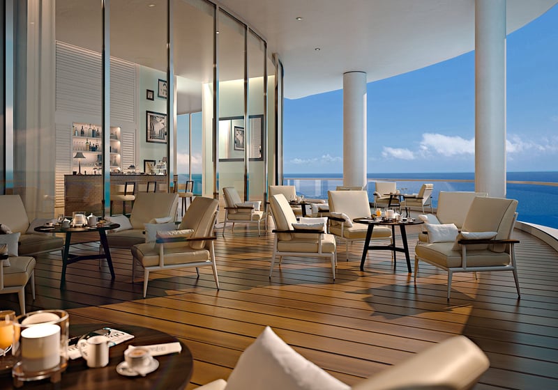 Oceanfront club terrace with lounge seating and a bar opening to the sea at The Ritz-Carlton Residences, Sunny Isles Beach, luxury and ultra luxury condos in Sunny Isles Beach.