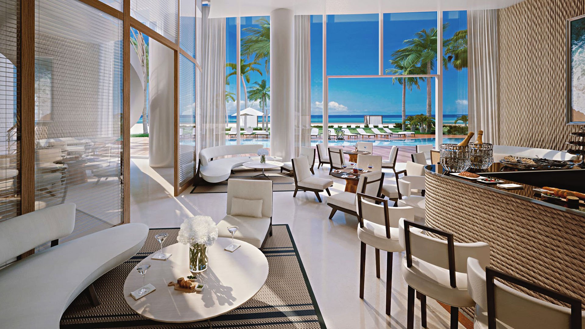 Poolside lounge and bar with indoor seating and views to the deck and ocean at The Ritz-Carlton Residences, Sunny Isles Beach, luxury and ultra luxury condos in Sunny Isles Beach.