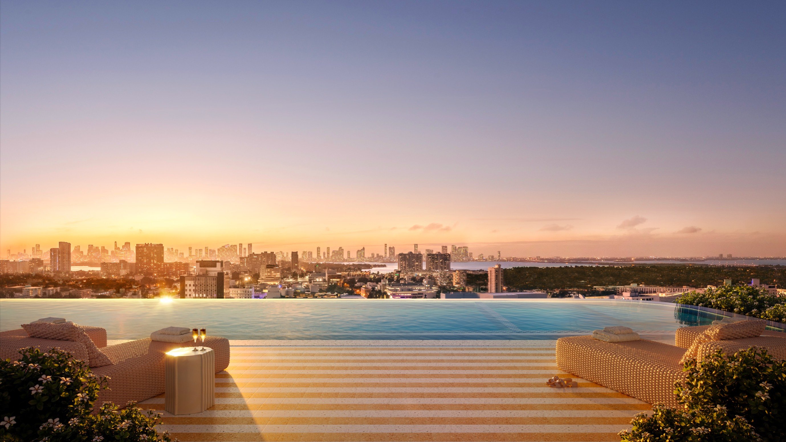 The Ritz‑Carlton South Beach rooftop infinity pool at sunset, Miami Beach, sky‑level amenity for luxury and ultra luxury condos; resale. Featuring view.