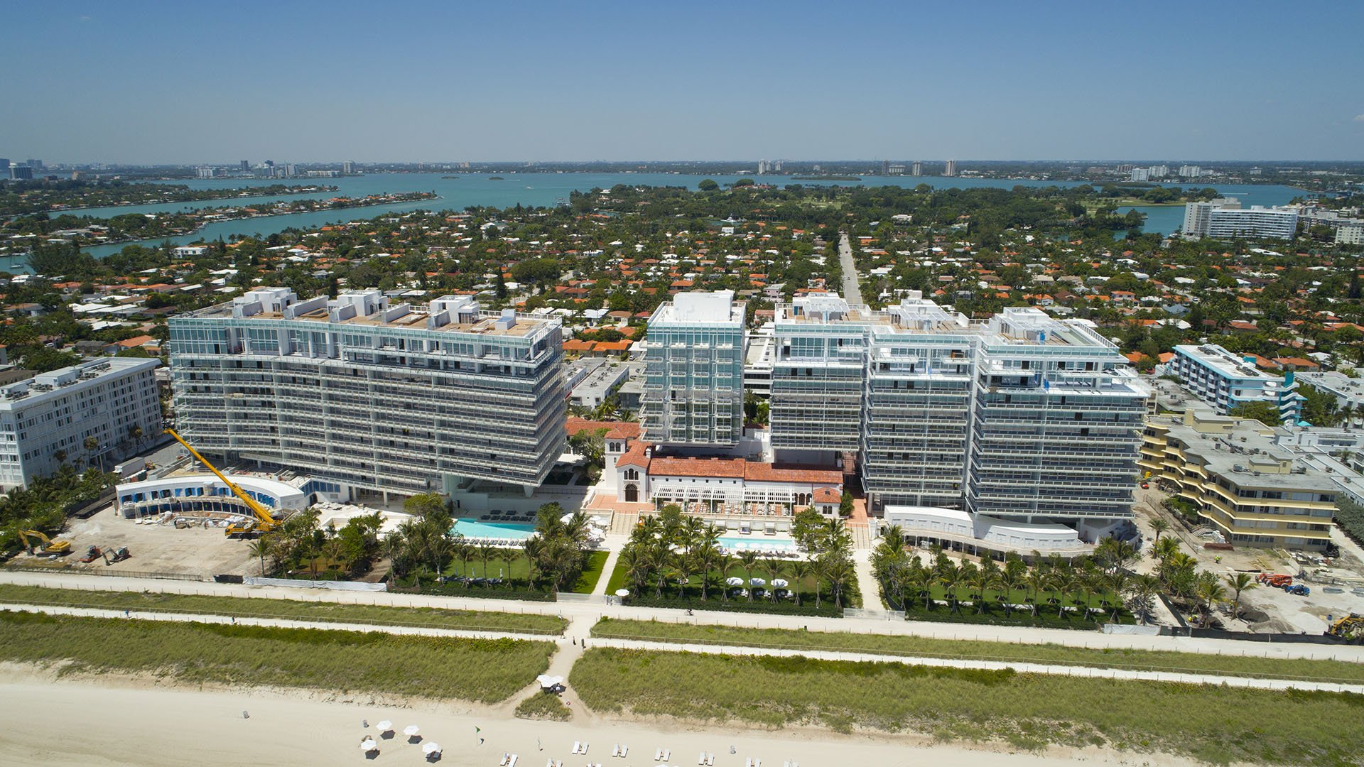 Aerial view of the beachfront condo campus and shoreline at The Surf Club Four Seasons, Fort Lauderdale, a community of luxury and ultra luxury condos.