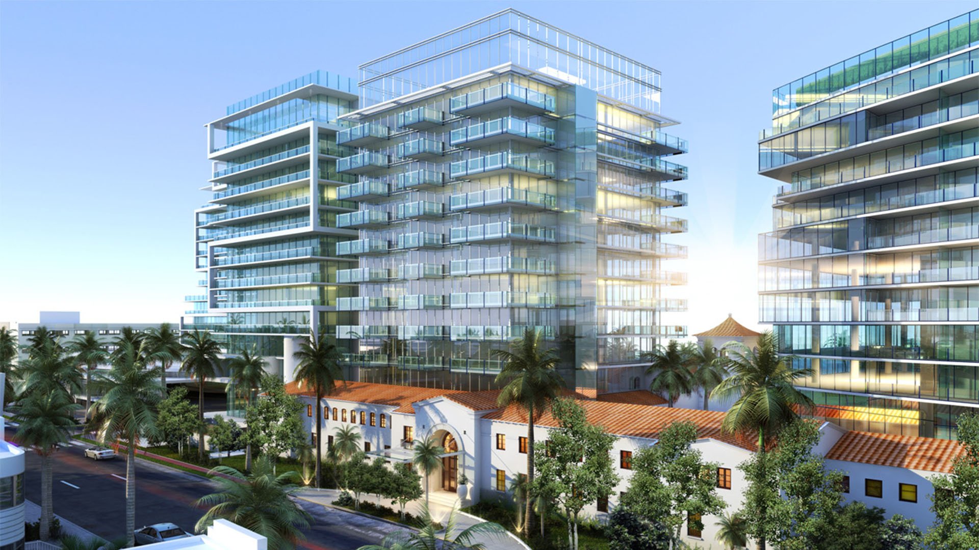 Glass condo towers rising above a palm-filled courtyard and low-rise buildings at The Surf Club Four Seasons, Fort Lauderdale luxury and ultra luxury condos.