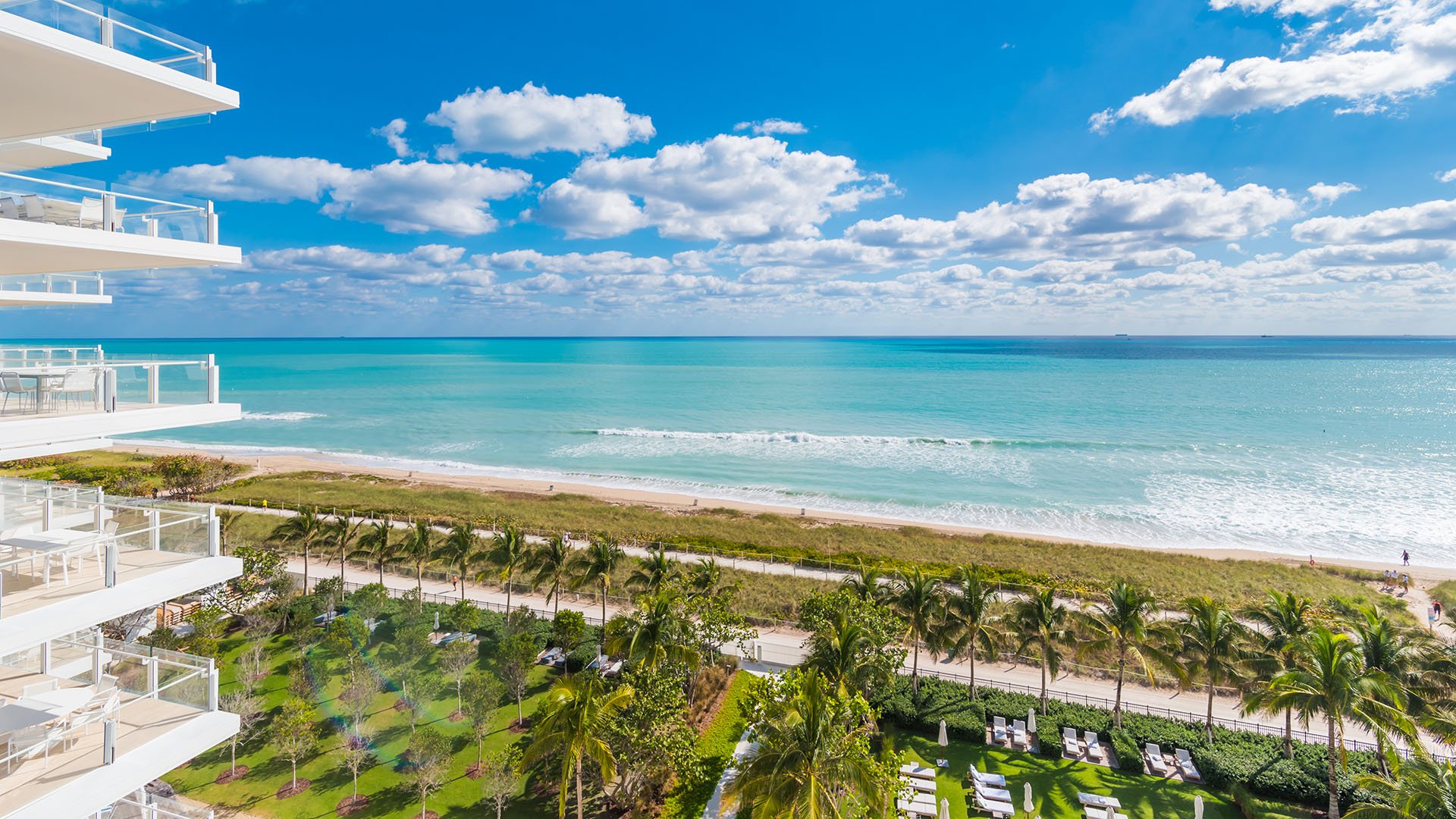 Ocean view framed by stacked glass balconies and the landscaped beachfront below at The Surf Club Four Seasons, Fort Lauderdale luxury and ultra luxury condos.