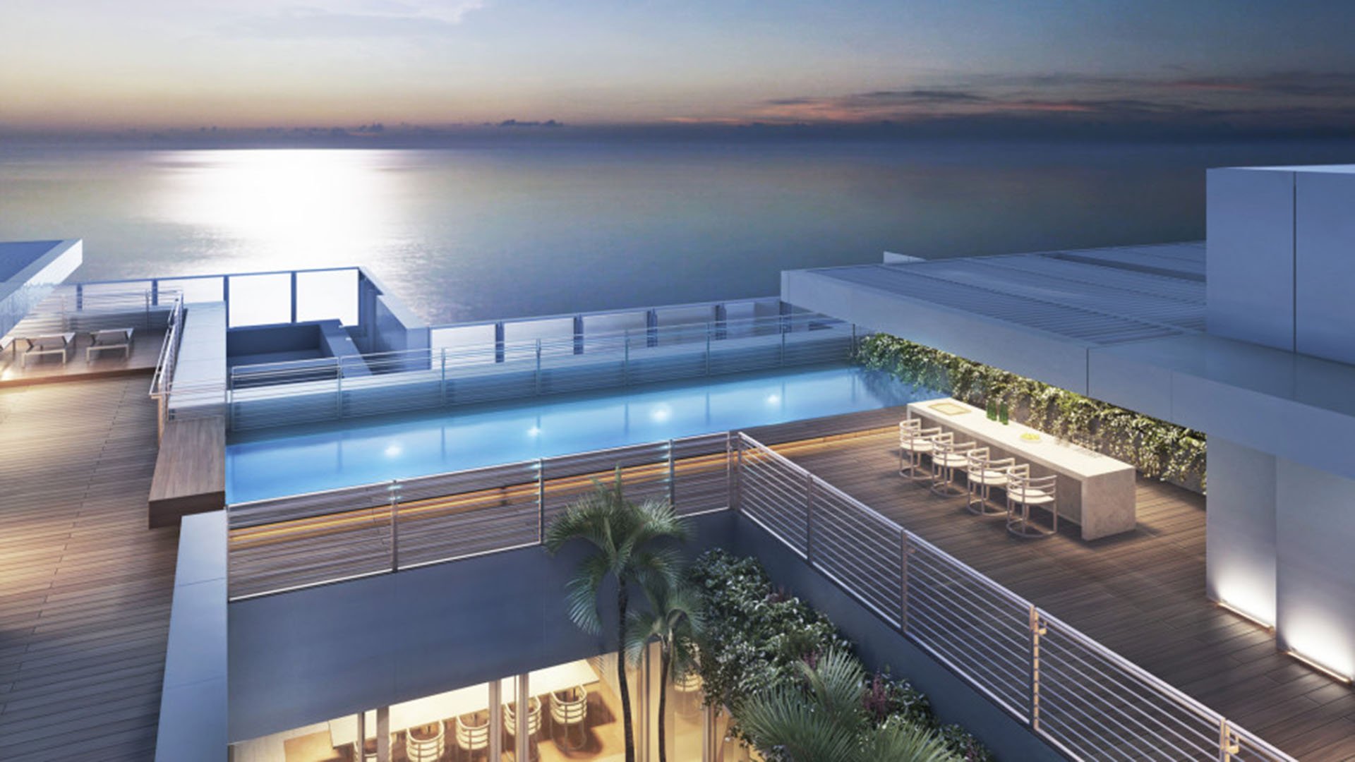 Rooftop pool terrace with a sunset bar lounge and calm ocean horizon at The Surf Club Four Seasons, Fort Lauderdale luxury and ultra luxury condos.