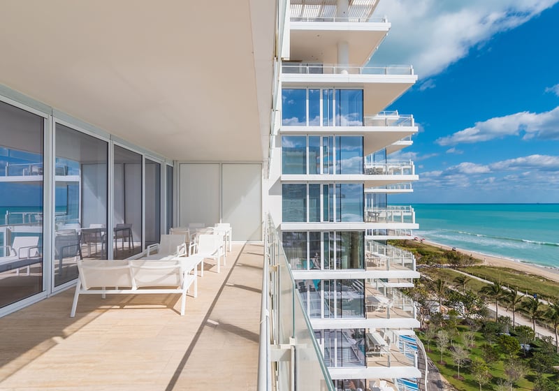 Wraparound terrace running beside the tower with lounge chairs and open ocean views at The Surf Club Four Seasons, Fort Lauderdale luxury and ultra luxury condos.