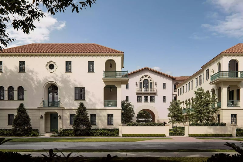 The Village at Coral Gables in Coral Gables, Miami daytime street view of Spanish Mediterranean village with balconies, arched entry and landscaped courtyards; luxury and ultra luxury preconstruction condos.