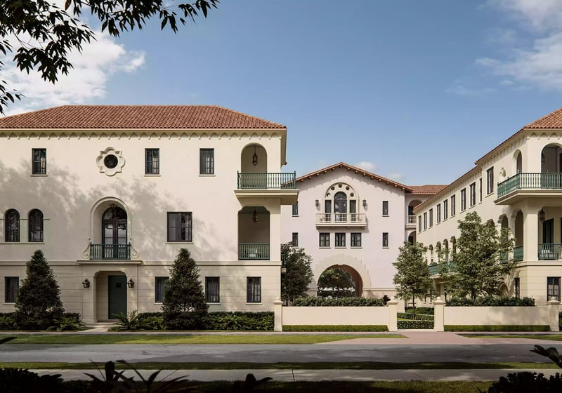 The Village at Coral Gables in Coral Gables, Miami daytime street view of Spanish Mediterranean village with balconies, arched entry and landscaped courtyards; luxury and ultra luxury preconstruction condos.