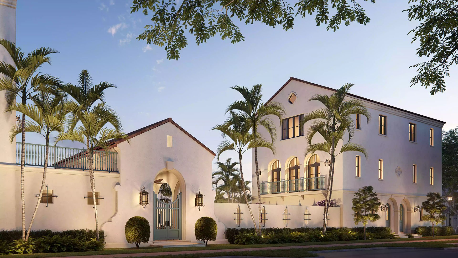 The Village at Coral Gables entry gate in Coral Gables, Miami at sunset with palm-lined Spanish Mediterranean buildings, arched windows and balcony railings; luxury and ultra luxury preconstruction condos.