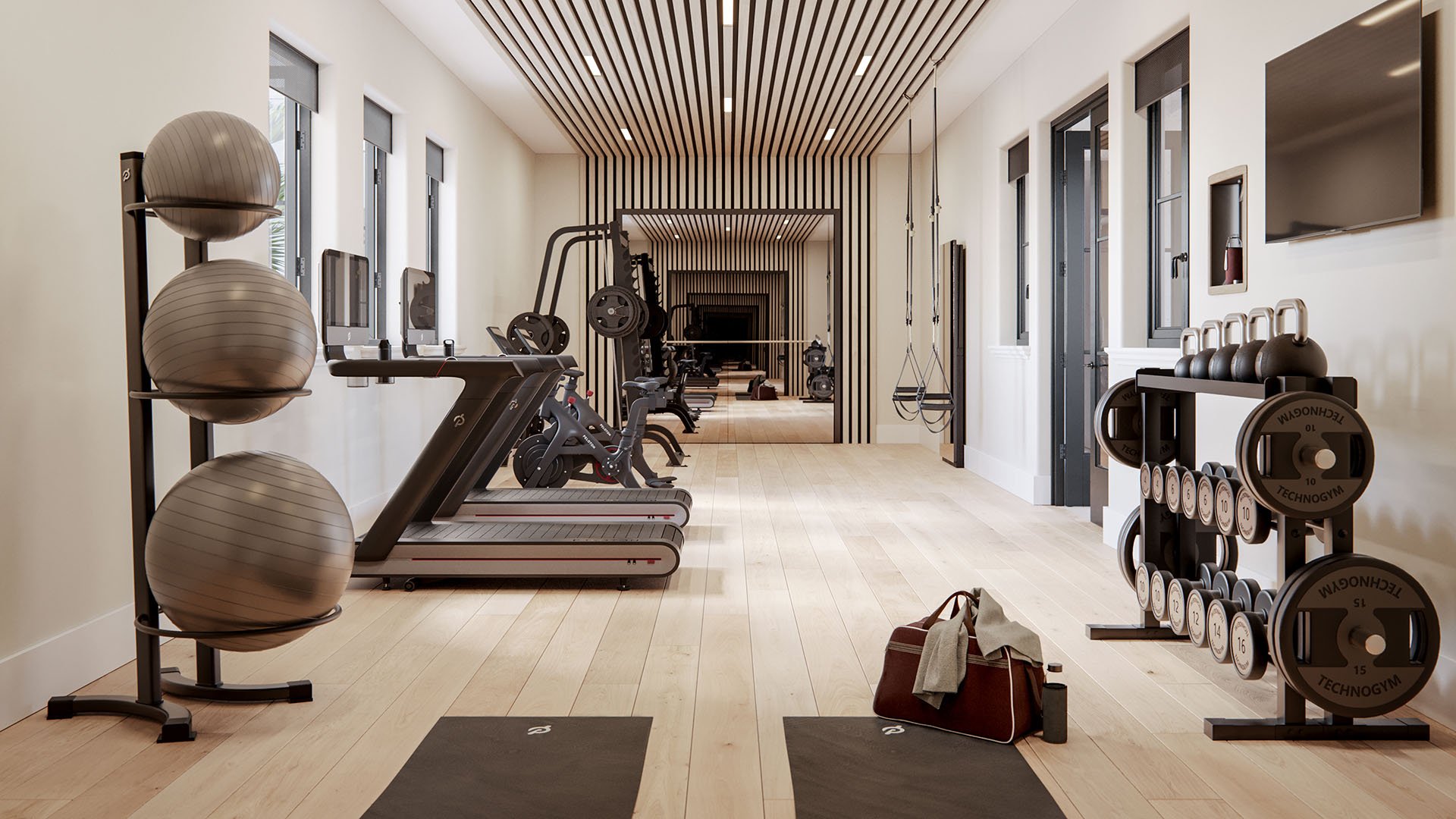 The Village at Coral Gables fitness center in Coral Gables, Miami with treadmills, bikes, free weights, mirrors and slat ceiling; luxury and ultra luxury preconstruction condos wellness amenity.