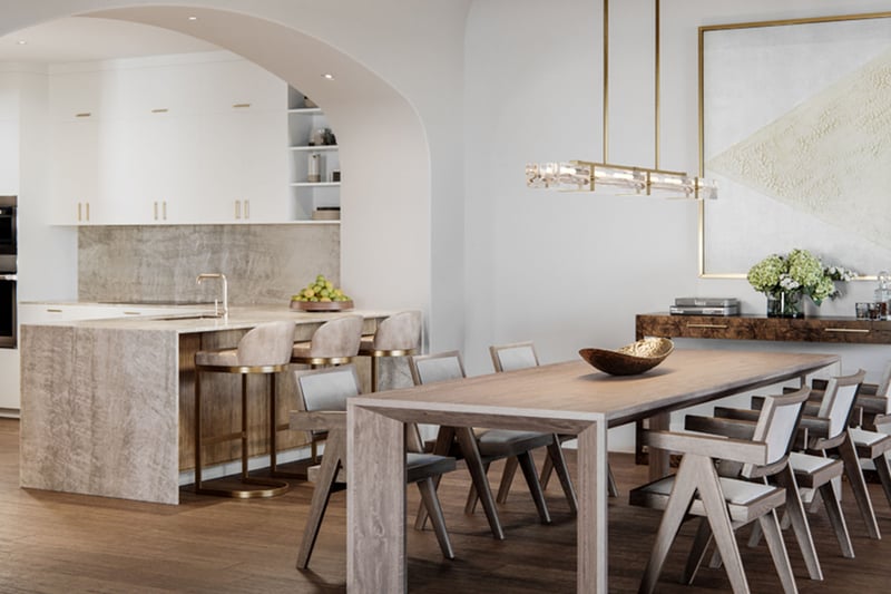 The Village at Coral Gables flats open-concept kitchen and dining in Coral Gables, Miami with arched entry, oversized table, island seating and modern lighting; luxury and ultra luxury preconstruction condos.