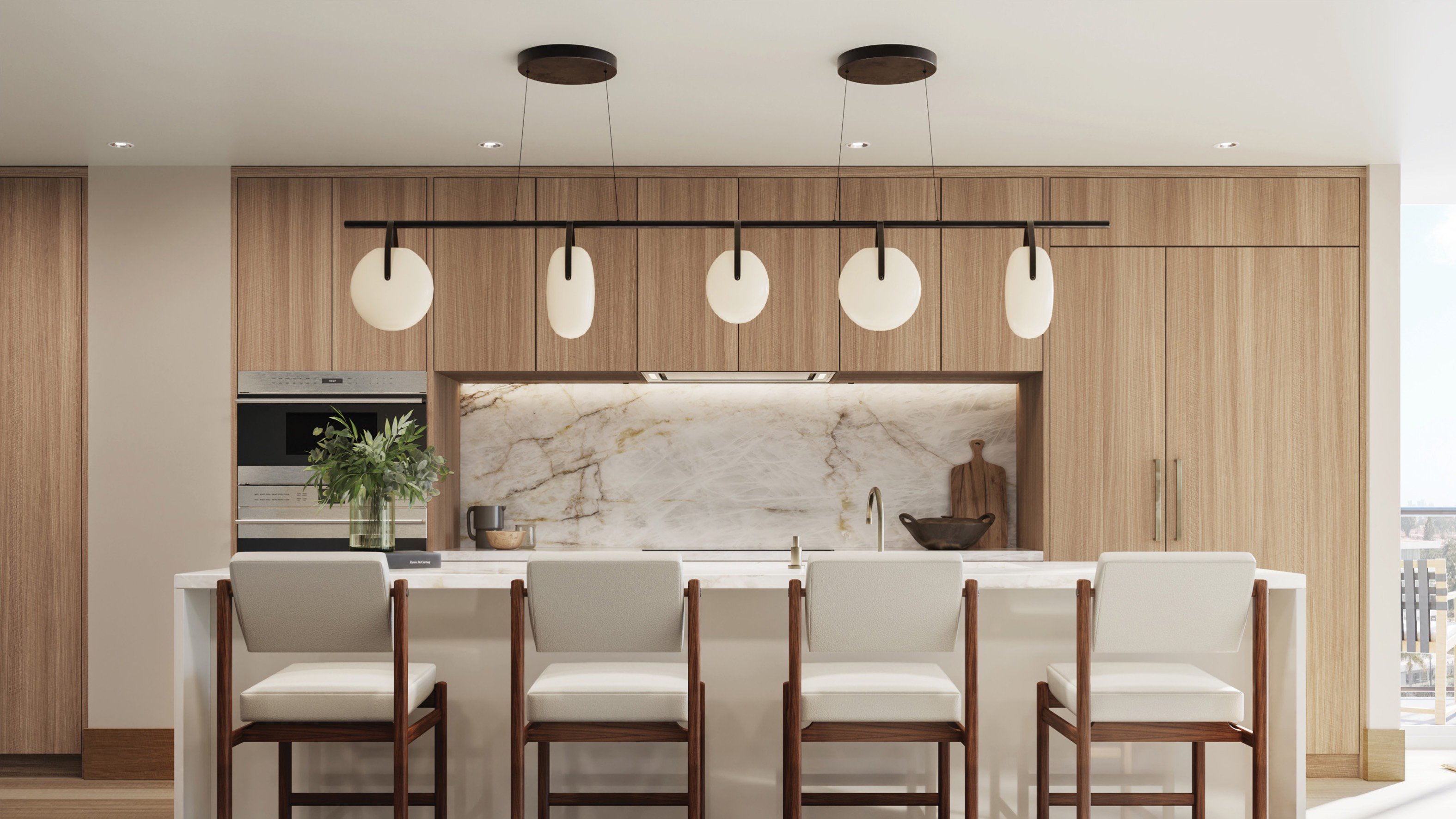 THE WELL Bay Harbor Islands, Miami chef’s kitchen interior design with island and integrated appliances, elevated living in luxury and ultra luxury condos; preconstruction. Featuring modern.