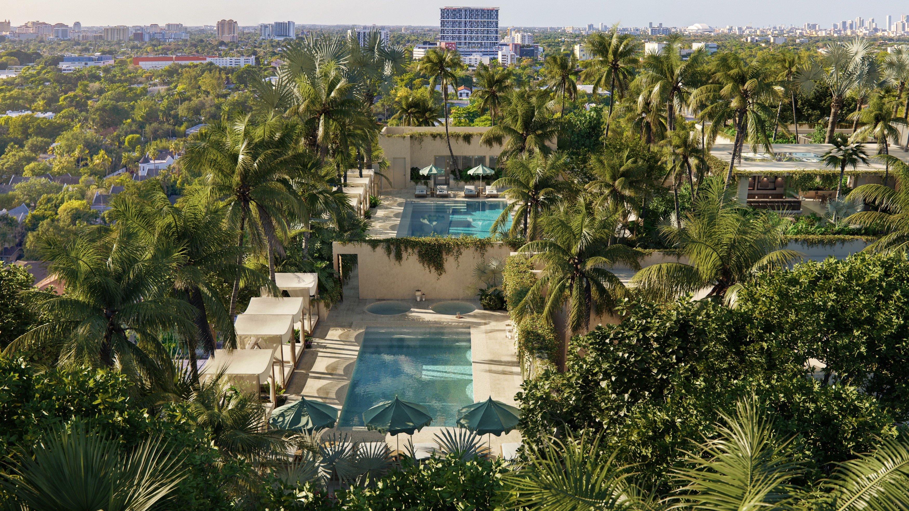 THE WELL Coconut Grove, Miami resort view with pools and palms—wellness‑focused grounds serving luxury and ultra luxury condos; preconstruction.