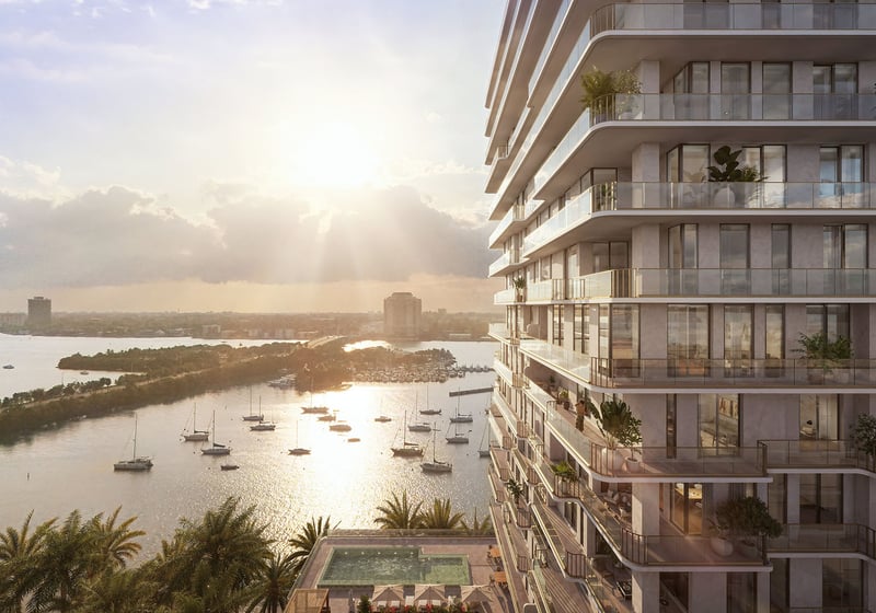 Aerial bayfront view of the tower and surrounding shoreline at Tula Residences in North Bay Village, showcasing luxury and ultra luxury condos with curved terraces, waterfront positioning, and a prominent coastal skyline presence.