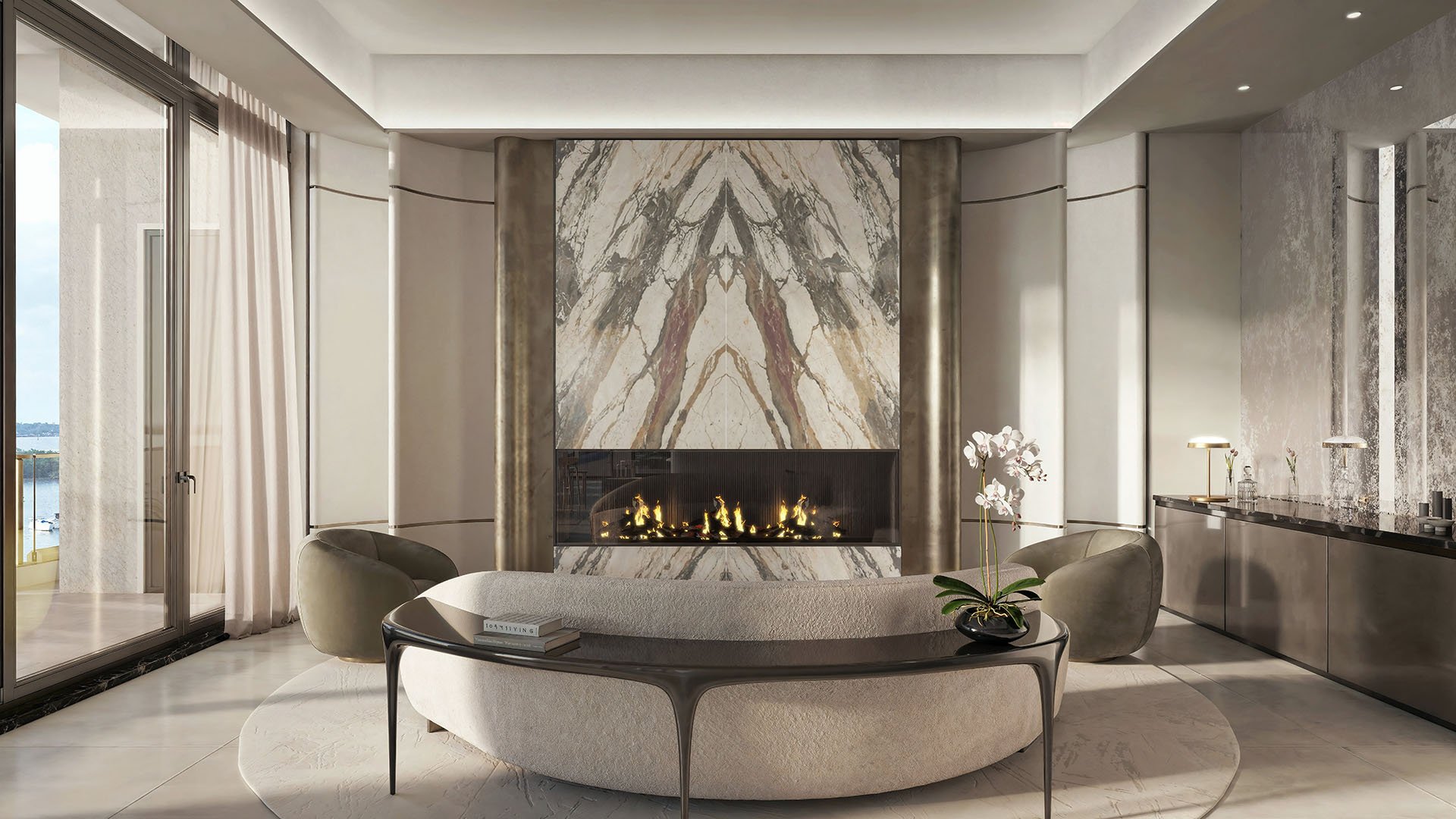 Lounge with a dramatic marble fireplace wall and circular sofa seating at Tula Residences in North Bay Village, expressing luxury and ultra luxury condos through curated amenity spaces and polished contemporary interiors.