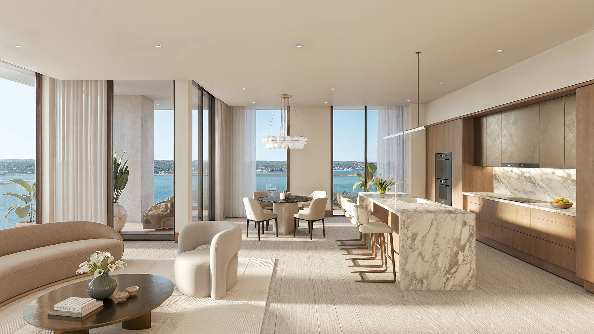 Open-plan living, dining, and chef kitchen area with water views at Tula Residences in North Bay Village, conveying luxury and ultra luxury condos through bright natural light, refined finishes, and seamless entertaining flow.