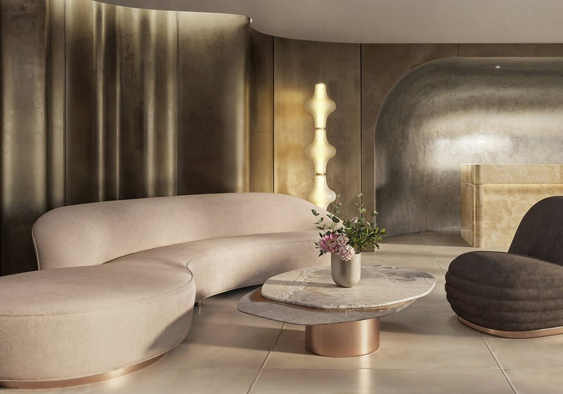 Sculptural lobby with a curved sofa, stone reception desk, and moody metallic finishes at Tula Residences in North Bay Village, introducing luxury and ultra luxury condos with a bold boutique arrival experience.