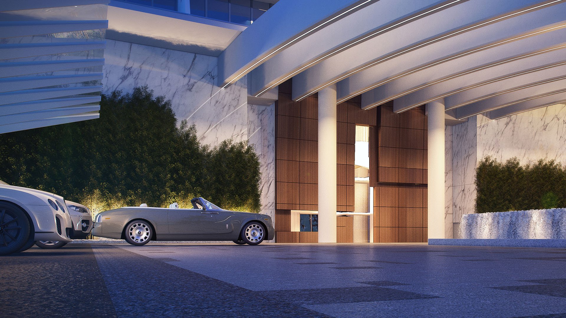 Turnberry Ocean Club in Sunny Isles Beach luxury and ultra luxury condos showcase an arrival entrance at dusk with a sweeping canopy, luxury cars, and marble walls.